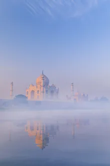 India, Taj Mahal reflecting in the Yamuna river on a foggy morning India, Taj Mahal reflecting in the Yamuna river on a foggy morning