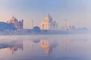 India, Taj Mahal reflecting in the Yamuna river on a foggy morning