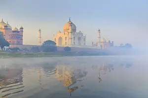India, Taj Mahal reflecting in the Yamuna river on a foggy morning