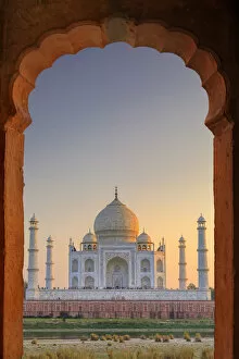 Memorial Collection: India, Taj Mahal at sunset framed by a temple arch