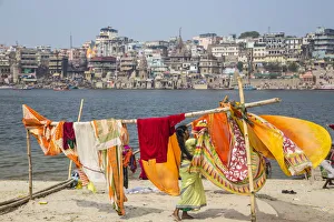 Ganges River Prints: India, Uttar Pradesh, Varanasi, Hanging up washing on banks of Ganges river