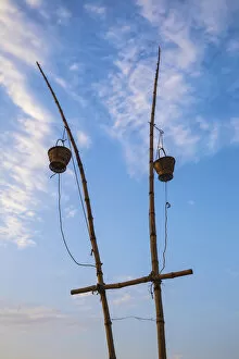 India, Uttar Pradesh, Varanasi, Sindhia Ghat, Wicker baskets on bamboo poles containing