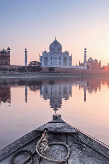 Images Dated 9th February 2018: India, view of the Taj Mahal reflecting in the Yamuna river at sunset from a wooden boat