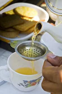 India, West Bengal, Darjeeling, Arya Tea Estate, Manager pouring cup of tea