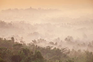 Images Dated 5th November 2012: Indonesia, Java, Magelang, Mist hovering over Borobudur Temple at dawn