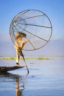 Images Dated 7th September 2020: Intha fisherman with a traditional conical fishing net against clear sky, Lake Inle