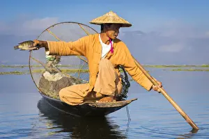 Nautical Vessels Prints: Intha fisherman with a traditional conical fishing net showing fish against clear sky