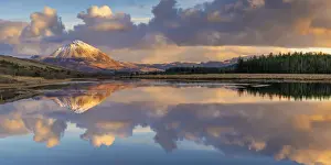 Ireland, Co. Donegal, Snow capped Errigal mountain reflected in Clady river at dusk