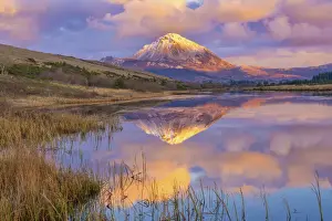 Ireland, Co. Donegal, Snow capped Errigal mountain reflected in Clady river at dusk