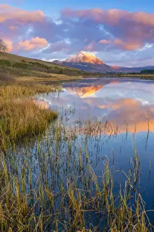 Ireland, Co. Donegal, Snow capped Errigal mountain reflected in Clady river at dusk