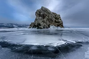 An island surrounded with flat ice over lake Baikal, Irkutsk region, Siberia, Russia