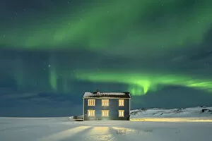 Isolated house in the snow lit by Northern Lights, Veines, Kongsfjord, Varanger Peninsula