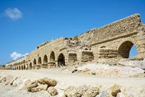 Israel, Haifa District, Caesaria. Ruins of Roman aqueduct on the beach along the