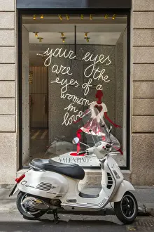 Milan Prints: Italian Vespa scooter parked in Via Montenapoleone fashion street with Valentino shop