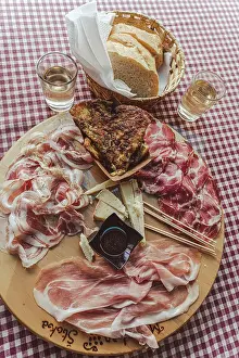 Bacon Prints: Italy, Friuli Venezia Giulia. A plate with cold cuts at a typical Osmiza - a temporary tavern