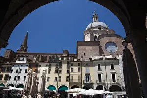 Italy, Lombardy, Mantua, archway view of Piazza Broletto and Basilica di Sant Andrea