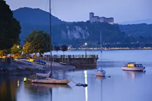 Italy, Piedmont, Lake Maggiore, Arona, lakefront view with La Rocca fortress in Angera