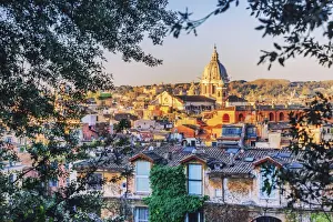 Italy, Rome, Basilica Sant Ambrogio e Carlo church and city roofs at sunrise