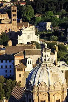 Italy, Rome, elevated view of Colosseum and Roman Forum at sunset