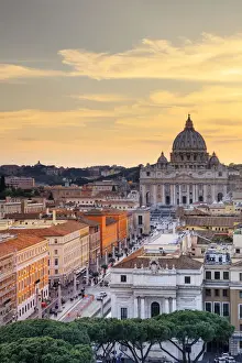 Italy, Rome, St. Peter Basilica and Via della Conciliazione elevated view at sunset