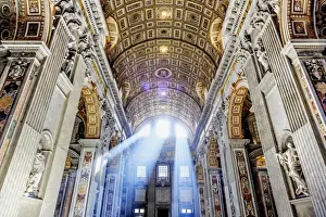 Italy, Rome, St. Peter Basilica interior with sun lights penetrating through
