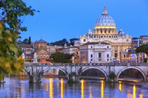 Italy, Rome, St. Peter Basilica by night reflecting on Tevere river