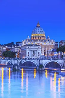 Italy, Rome, St. Peter Basilica by night reflecting on Tevere river