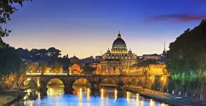 Italy, Rome, St. Peter Basilica by night reflecting on Tevere river