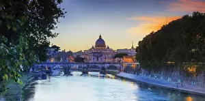 Italy, Rome, St. Peter Basilica by night reflecting on Tevere river