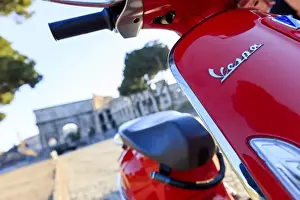 Vespa Prints: Italy, Rome, a young couple on a red Vespa motorbike enjoying the sunset at Colosseum