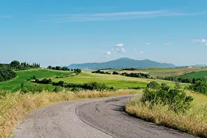Winding Road Prints: Italy, Tuscany, Crete Senesi: Winding road through rolling hills under a bright blue sky