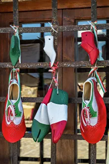 Italy, Tuscany, Province of Siena. Monteriggioni. a beautifully decorated shop of a shoemaker