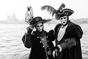 Images Dated 3rd March 2023: Italy, Veneto, Venice, a black and white version of a couple in costume in front of Salute during