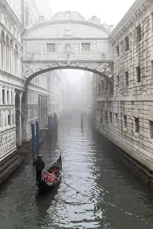Bridge Of Sighs Prints: Italy, Veneto, Venice, a gondola moves towards the bridge of Sighs on a foggy day