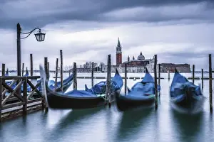 Italy, Veneto, Venice. Gondolas at dawn with San Giorgio Maggiore church on the background