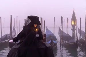 Candle Prints: Italy, Veneto, Venice, a model poses in costume during the Venice Carnival on a foggy day