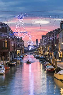 Images Dated 5th January 2015: Italy, Veneto, Venice, Murano island. Canal at sunset with Christmas lights hanging