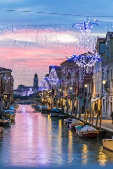 Images Dated 5th January 2015: Italy, Veneto, Venice, Murano island. Canal at sunset with Christmas lights hanging