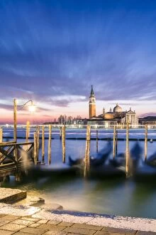 Lagoon Gallery: Italy, Veneto, Venice. Row of gondolas moored at sunrise on Riva degli Schiavoni