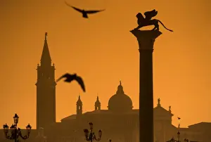 Sun Rise Prints: Italy, Veneto, Venice; San Giorgio Maggiore in the background with the lion of Venice in the foreground