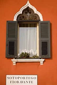 Italy, Veneto, Venice; A typical Ventian window with persiane - shutters which keep out too much light while leaving the possibility to