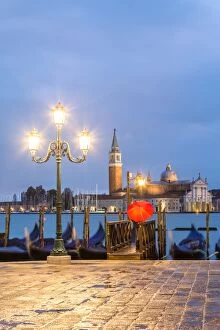 Umbrella Gallery: Italy, Veneto, Venice. Woman with red umbrella on Riva degli Schiavoni at dawn (MR)
