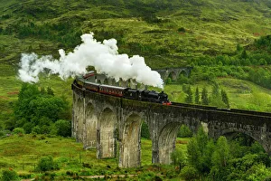 Jacobite steam train crossing Glenfinnan Viaduct, Glenfinnan, Inverness-shire, Scottish Highlands, Scotland, UK
