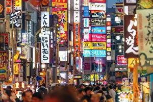 Highways Prints: Japan, Tokyo, Crowds walk under bright neon signs in Shinjuku's Kabukicho district