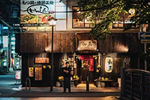 Dark Prints: Japanese chef in front of a restaurant at night in Kyoto, Japan