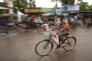 Images Dated 7th April 2016: Jessore, Bangladesh. A man cycles to work through the centre of town