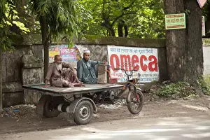 Roadside Prints: Jessore, Bangladesh. Two men take a rest from transporting goods around Jessore