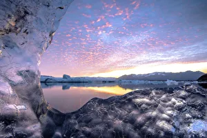 Jokulsarlon glacier lagoon, East Iceland. The lagoon seen from a transparent block of ice Jokulsarlon glacier lagoon, East Iceland. The lagoon seen from a transparent block of ice