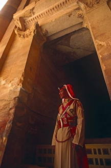 Jordan, Petra. A Jordanian policeman stands at the entrance to Petras famous Treasury Jordan, Petra. A Jordanian policeman stands at the entrance to Petras famous Treasury