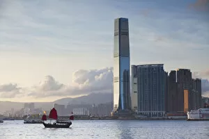 Junk boat passing International Commerce Centre (ICC), West Kowloon, Hong Kong